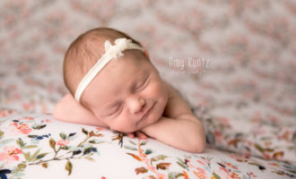 Picture of a baby girl on a floral backdrop