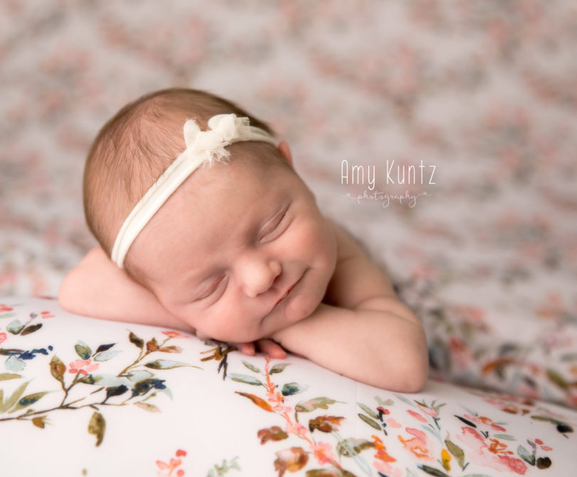Picture of a baby girl on a floral backdrop