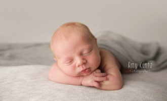 sleeping newborn baby at his photoshoot