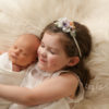baby boy and his sister at a newborn photo session