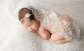 newborn posed with wedding veil